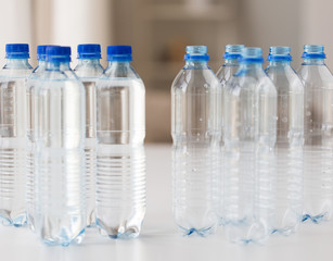 close up of bottles with drinking water on table