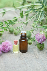 thistle oil container with thistle flowers