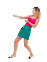 back view of standing girl pulling a rope from the top or cling to something. girl  watching. Rear view people collection.  backside view of person.  Isolated over white background. The blonde in a