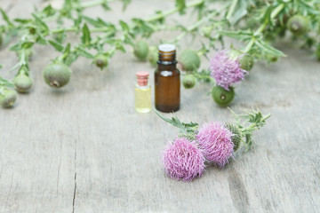 thistle oil container with thistle flowers