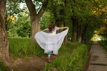 girl in fairy tale park with tree in spring