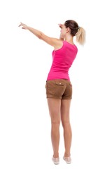 Back view of  pointing woman. beautiful girl. Rear view people collection.  backside view of person.  Isolated over white background. Blonde in brown shorts saw something interesting on the left.