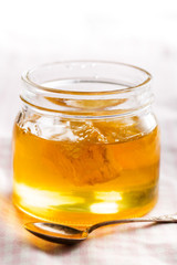 Honeycomb in jar with honey.