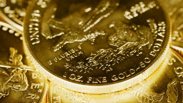 4K Macro Video With Close Up Of The Words 1 Oz Pure Gold On A Rotating Gold Eagle US Mint Coin Representing Safe Investment Or Return To Gold Standard