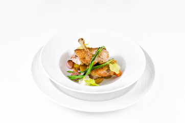 Chicken ham with crispy caramel crust and onions on a plate on a white background