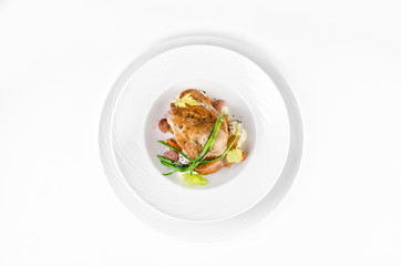 Chicken ham with crispy caramel crust and onions on a plate on a white background, top view