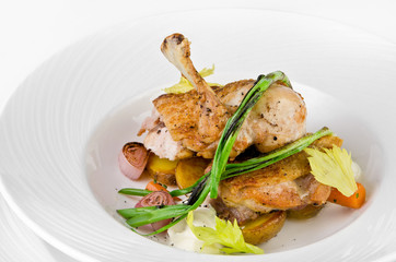 Chicken ham with crispy caramel crust and onions on a plate on a white background, closeup