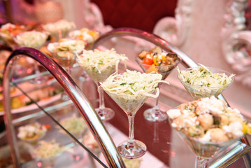 Different kinds of salads served in cocktail glasses