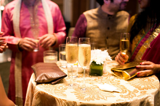 Glasses of cold champagne stand on the table surrounded by India