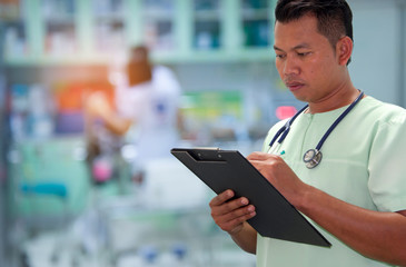 Doctor writing a medical prescription in hospital