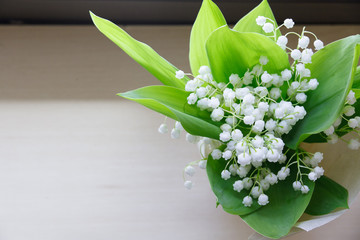 Lily of the valley on wooden background.   the  bouquet.
