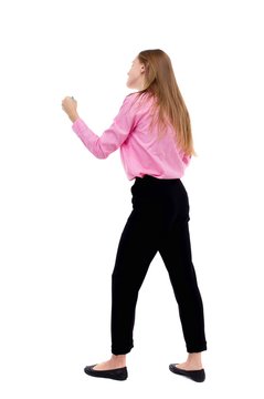 skinny woman funny fights waving his arms and legs. Isolated over white background. Woman office worker in a pink shirt standing in a boxing stance.