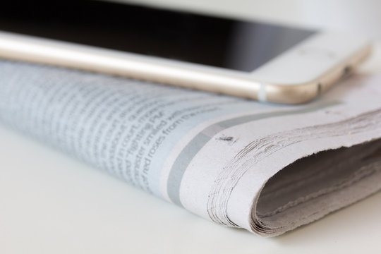 selective focus of corner newspaper, smart phone on newspaper
