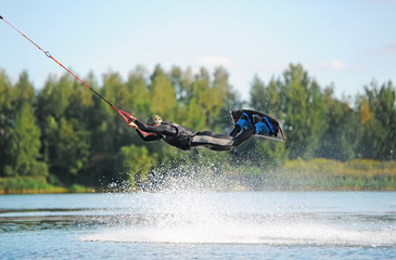 Man does wakeboarding sport.