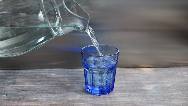 Pouring fresh water into glass