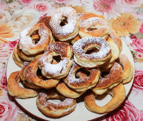 Obraz na płótnie Canvas Donuts in powdered sugar on a plate.