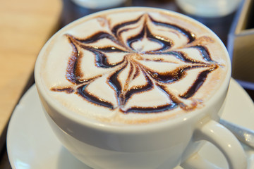 Art on the top cream of hot chocolate or latte coffee cup