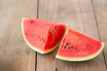 Fototapeta na wymiar watermelon on brown wooden background