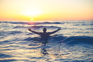 filtered colors- man with positive vibration in front of sun,  sunset in a beautiful beach, holidays