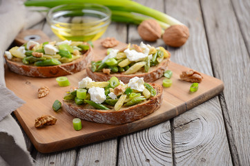 Bruschetta with french beans, green onions, feta cheese and walnuts, selective focus, copy space