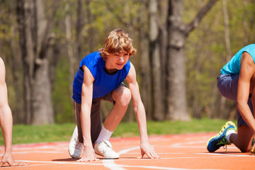 Teenage boy getting ready for race on the track