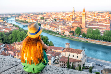 Woman enjoying beautiful view on Verona city in Italy on the sunrise. Verona is famous city of love...