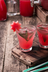Watermelon drink in glasses with slices of watermelon mint and lemon, vintage background ,soft focus