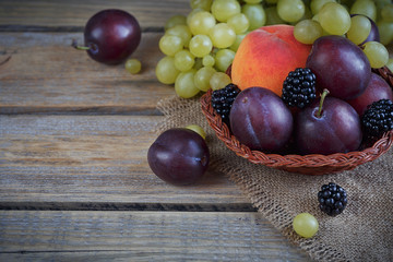 Mix of fresh berries and fruits on rustic wooden background