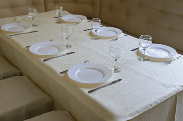 Served table in restaurant with dishes and glasses