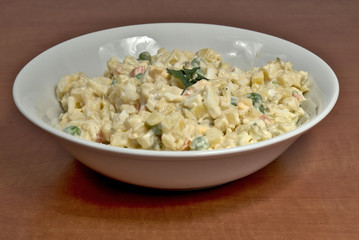 Homemade potato salad in white ceramic plate