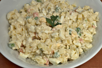Homemade potato salad in white ceramic plate