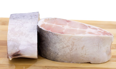 frozen fish steaks on the table background