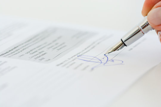 Sign a contract or agreement with a pen