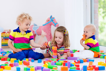 Kids playing with colorful toy blocks