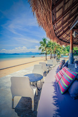 Sofa seats and pillows with chairs in front of the beach, Vintag