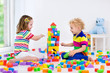 Kids playing with colorful toy blocks