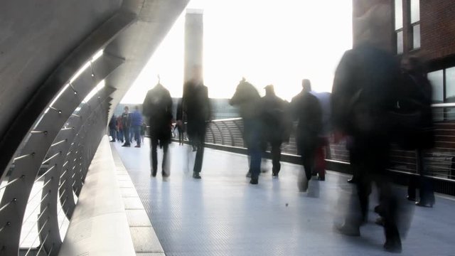 people crossing the millenium bridge