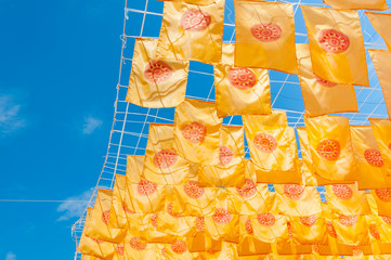 Thammachak flag yellow in temple (Wat Phan tao) on blue sky temple Northern Thailand