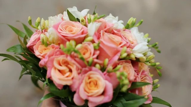 Beautiful flower bouquet with orange pink roses and yellow ranunculus on colorful background