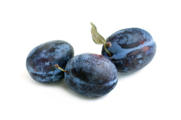 Ripe plums close-up on white background