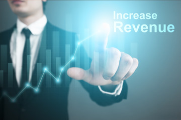 Businessman is pressing on the virtual screen and selecting "Increase revenue".