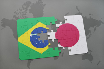 puzzle with the national flag of brazil and japan on a world map background.