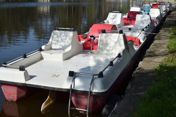 Fototapeta na wymiar Closeup of pedal boats, parked in a row on Zlatibor lake