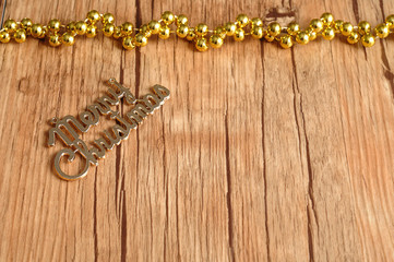 Merry Christmas text on a wooden background with open space for
