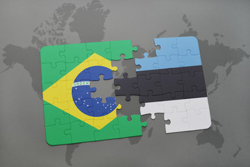 puzzle with the national flag of brazil and estonia on a world map background.