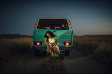 Serious young woman hippie van in car