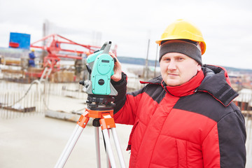 Surveyor working with theodolite equipment