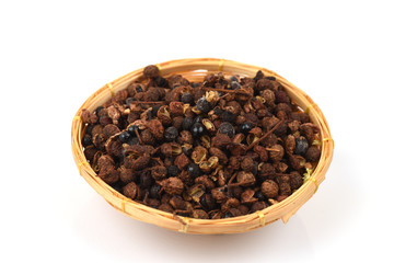 Sichuan Pepper (Chinese Pepper) spices, medicinal properties in a basket on a white background.