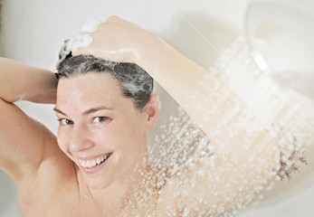 Shower woman. Happy smiling woman washing shoulder showering in