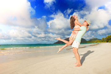 young couple in love having fun at tropical beach. Praslin, Seychelles